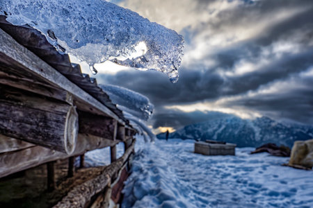 Snow on a wood depot in the Italian alps in a winter dayの写真素材