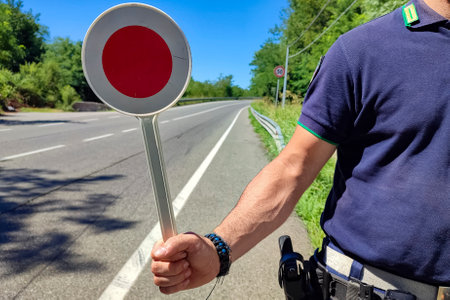 Policeman with a paddle close-upの写真素材