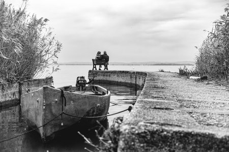 Couple on a bench on Lake Garda lakesideの写真素材