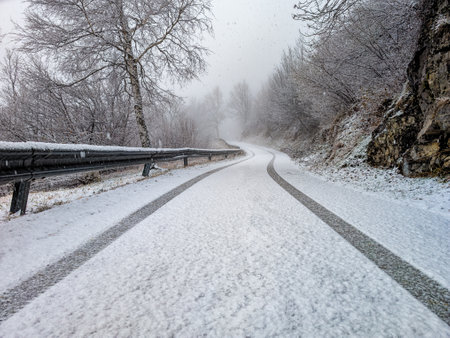 Snow on a road in winter season in the Italian pre-Alpsの写真素材