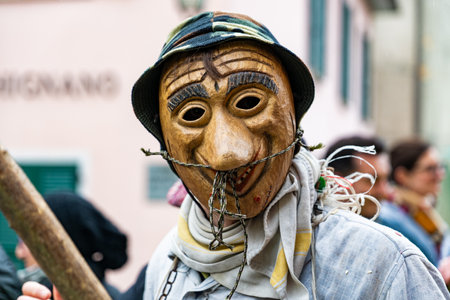 Shignano (Italy) 01/03/23: The carnival of Schignano parade is one of the most famous traditional carnivals of northern Italy with typical wooden masks and performers that entertain the visitors.の写真素材