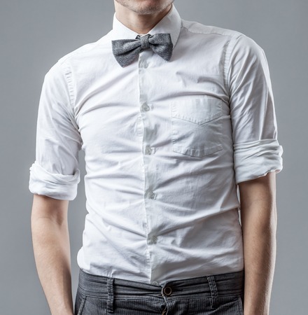 Stylish man in a white shirt with gray striped butterfly on a neck. The official style of clothesの写真素材