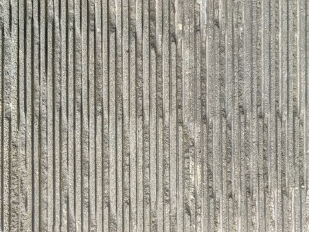 Old gray cracked cement wall, close up. Texture of striped ancient stone, backgroundの写真素材