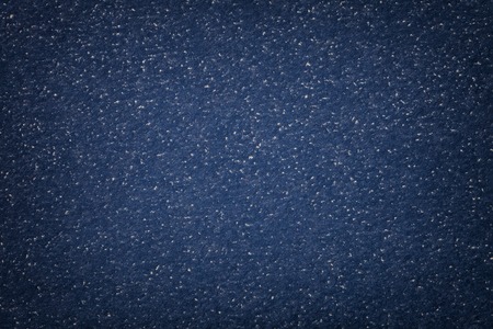Texture of old dark navy blue paper closeup. Structure of a dense cardboard. The denim background with vignette frame.の写真素材