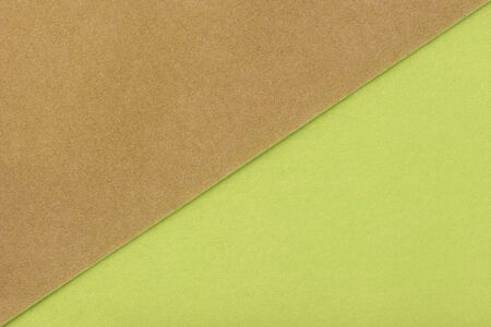 Two color background brown and green shade. Colorful paper divided in half. Matt suede fabric closeup. Velvet texture of felt.の写真素材
