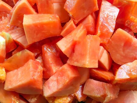 Ripe juicy sliced of orange papaya. Tropical food backgroound. Pieces of asian vegetarian sweet fruit.の写真素材