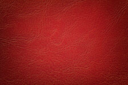 Dark red leather texture background, closeup. Brick cracked backdrop from wrinkle skin, structure of textile with vignette.の写真素材