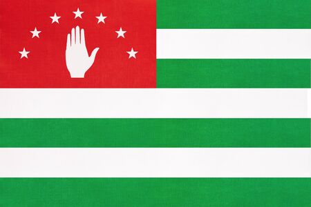 Abkhazia national fabric flag with emblem, textile background. Symbol of international world european country. State official abkhazian sign.の写真素材