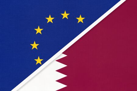 European Union or EU and State of Qatar national flag from textile. Symbol of the Council of Europe association opposite Asian country. Europe championshipの写真素材