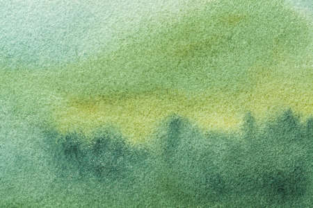 Abstract art background light olive and green colors. Watercolor painting on canvas with soft cyan gradient. Fragment of artwork on paper with emerald pattern. Texture backdrop.の写真素材