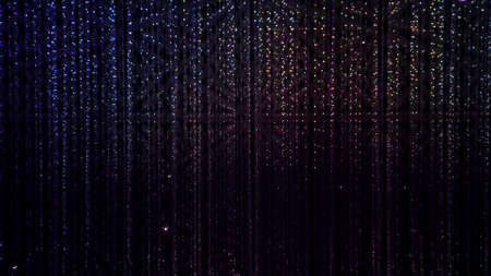 Multicolored background of LED flashing, blinking and flickering bulbs. Christmas and holiday illuminated neon shiny backdrop. Wall decoration from twinkle garland for party. New year illumination.の写真素材