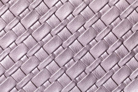 Texture of light purple leather background with wicker pattern, macro. Abstract backdrop from modern...