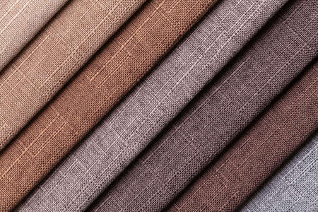 Sample of woven textile brown and gray colors, background. Catalog and palette tone of Interior fabric for furniture, closeup. Collection of multicolored cloth with wicker pattern.の写真素材