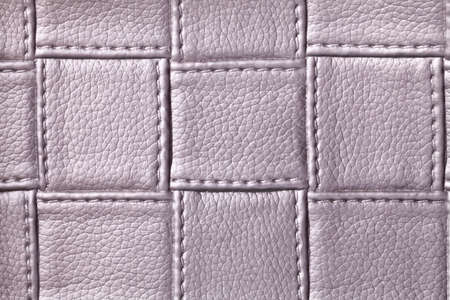 Texture of purple leather background with square pattern and stitch, macro. Abstract backdrop from modern decorative light violet textile with geometric shape.の写真素材