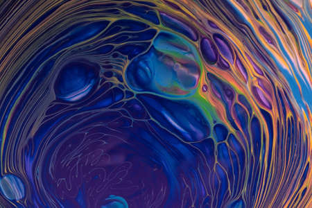 Abstract fluid art background navy blue and orange colors. Liquid acrylic painting on canvas with...