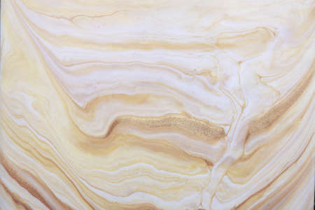 Abstract fluid art background light beige and golden colors. Liquid marble. Acrylic painting on canvas with white gradient and splash. Watercolor backdrop with waves pattern.の写真素材