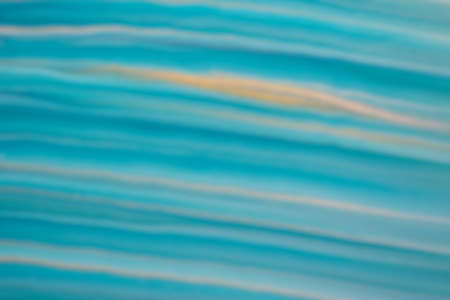 Blurred blue and golden background with turquoise lines. Defocused art abstract gradient backdrop with blur and bokeh.の写真素材