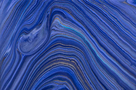 Abstract fluid art background navy blue and golden glitter colors. Liquid marble. Acrylic painting on canvas with dark sapphire gradient. Watercolor backdrop with wavy pattern. Stone section.の写真素材