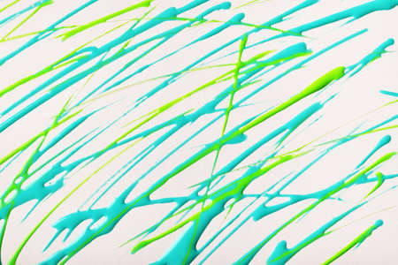 Thin green and blue lines and splashes drawn on white background. Abstract art backdrop with turquoise brush decorative stroke. Acrylic painting with graphic stripe.の写真素材