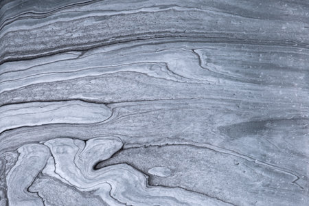 Abstract fluid art background light gray and silver colors. Liquid marble. Acrylic painting on canvas with graphite gradient. Watercolor backdrop with wavy pattern. Stone section.の写真素材