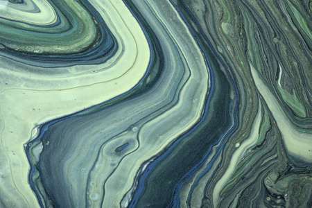 Abstract fluid art background green and blue colors. liquid marble. Acrylic painting on canvas with olive gradient. Watercolor backdrop with wavy pattern. Stone section.の写真素材