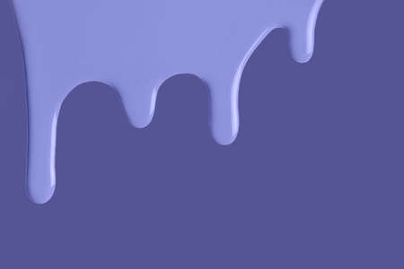Light blue liquid drops of paint color flow down on isolated very peri background. Abstract violet backdrop with fluid drip pattern. Acrylic painting with copy space.の写真素材