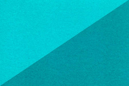 Texture of craft light blue and turquoise paper background, half two colors, macro. Structure of...