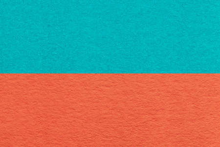 Texture of craft orange and cyan paper background, half two colors, macro. Structure of vintage dense cerulean cardboard. Felt backdrop closeup.の写真素材