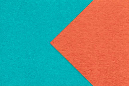 Texture of cyan and orange paper background, half two colors with arrow, macro. Structure of dense craft cerulean cardboard. Felt abstract backdrop closeup.の写真素材