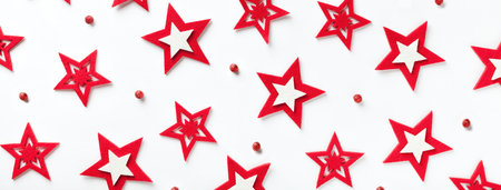 Christmas pattern of red stars on a white background. Backdrop for New Year greeting card. Abstract decorative holiday wallpaper, closeup. Xmas ornate.の写真素材