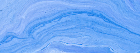 Abstract fluid art background light blue colors. liquid marble. Acrylic painting on canvas with denim gradient. Watercolor backdrop with wavy pattern. Stone section.の写真素材