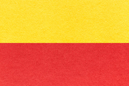 Texture of craft red and yellow paper background, half two colors, macro. Structure of vintage dense cardboard. Felt backdrop closeup.の写真素材