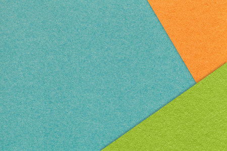 Texture of craft turquoise color paper background with orange and green border. Vintage abstract cerulean cardboard. Presentation template and mockup with copy space. Felt backdrop closeup.の写真素材