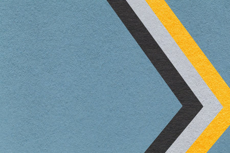 Blue gray paper texture background with yellow black chevron stripes and copy space for banner,...