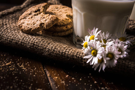 Fresh cookies with milk on old sackの写真素材