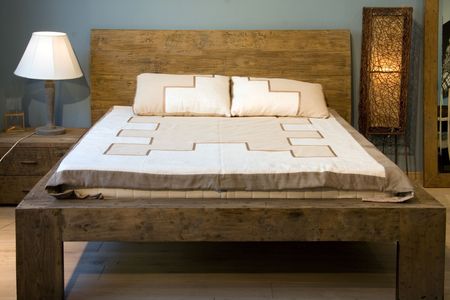 Bedroom with old-style wooden bedの写真素材
