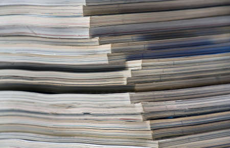 Stack of magazines at the bookshelfの写真素材