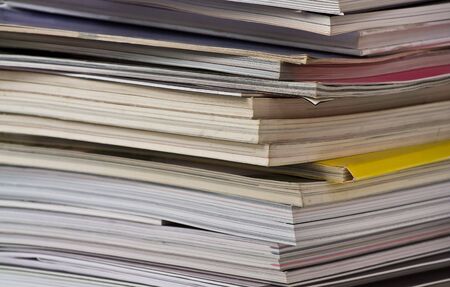 Stack of magazines at the bookshelfの写真素材