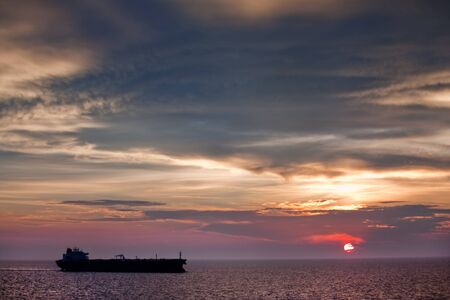 Silhouette of trade ship with sunsetの写真素材