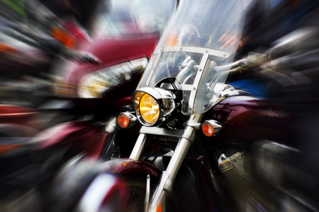 motorcycle rushing at city street, blurred motionの写真素材