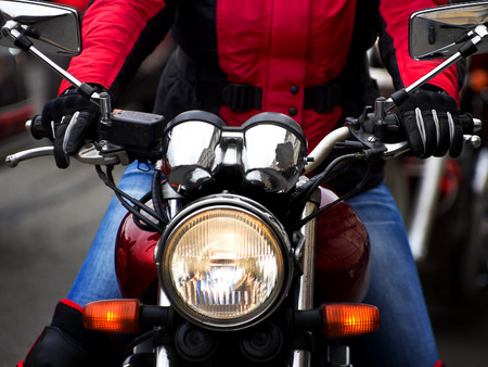 Motorcycle rider rushing at city streetの写真素材