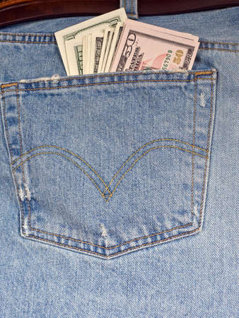 Background a back pocket of jeans with cash dollars inside