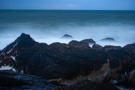 Closeup of Crashing Waves on Rocks Long Exposureの写真素材