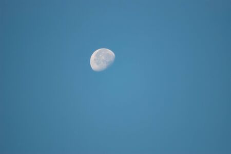 Bright White Moon Against the Blue Skyの写真素材
