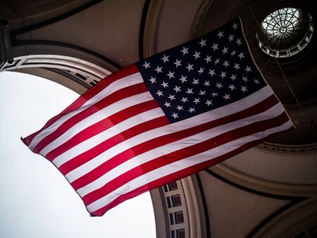 The American Flag Flies High Beneath An Archのeditorial素材