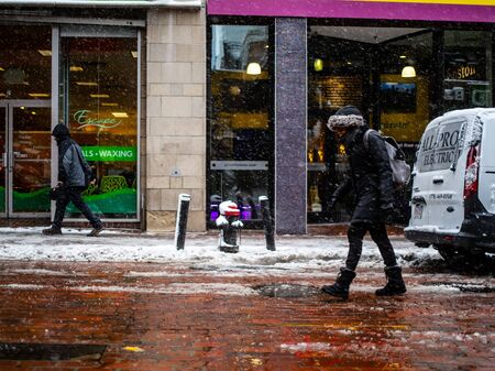A Woman Walks Through a Snow Stormのeditorial素材