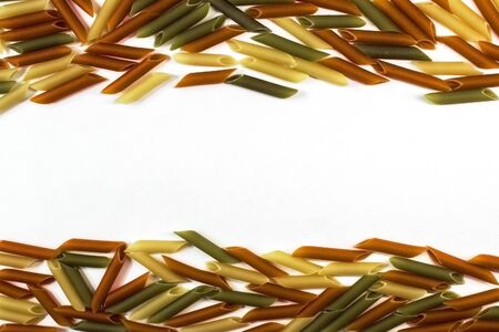 set of scattered pasta on white grey wooden background, closeup, top viewの写真素材