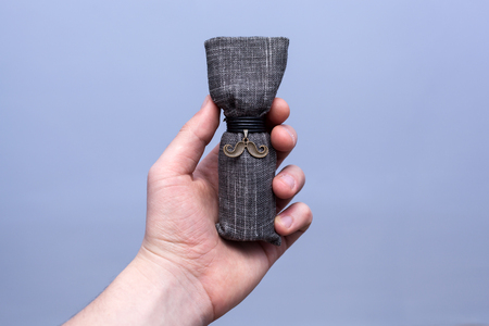 Man holding a luxury packaging of beard oilの写真素材