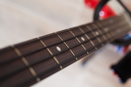 Bass guitar pictured from above with selective focus on the fretboardの写真素材