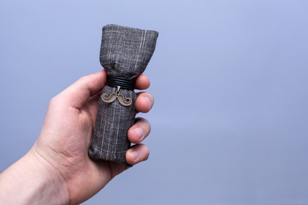 Man holding a luxurious packaging of beard oilの写真素材